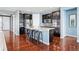 Well-appointed kitchen features dark cabinets, stainless appliances, and island with barstool seating at 7426 E 148Th Pl, Thornton, CO 80602