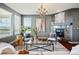 Bright living room featuring hardwood floors, a fireplace, and large windows at 7426 E 148Th Pl, Thornton, CO 80602