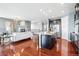 Spacious open-concept kitchen and living room with hardwood floors and stainless appliances at 7426 E 148Th Pl, Thornton, CO 80602