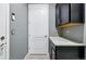 Mud room with dark cabinets and countertops, a door to the garage, and neutral tile floors at 7426 E 148Th Pl, Thornton, CO 80602