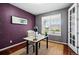 Office with hardwood floors, textured purple wall, modern desk, and a window at 7426 E 148Th Pl, Thornton, CO 80602