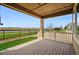 View from a covered patio featuring a wood-look floor, grass, and a neighborhood view at 7426 E 148Th Pl, Thornton, CO 80602