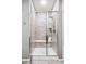 Bathroom walk-in shower with neutral tiles and a built-in bench, providing a spa-like experience at 7426 E 148Th Pl, Thornton, CO 80602
