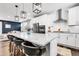 Bright kitchen features stainless steel appliances, white cabinetry, granite counters and a kitchen island with bar stool seating at 3560 Corsica Way, Castle Rock, CO 80109