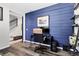 Office with a striking blue accent wall, hardwood flooring, and a modern desk setup at 3560 Corsica Way, Castle Rock, CO 80109