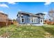 Backyard featuring a lawn and the back of a blue house with lots of windows at 10606 Cottoneaster Way, Parker, CO 80134