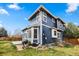 Blue two-story home featuring a grill and lots of windows in the backyard at 10606 Cottoneaster Way, Parker, CO 80134