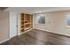 Spacious basement with wood flooring, built-in shelving, and a window at 10606 Cottoneaster Way, Parker, CO 80134