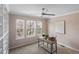 Bright room with decor, ceiling fan, and built-in bookshelves at 10606 Cottoneaster Way, Parker, CO 80134