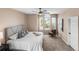 A bright bedroom with neutral paint, a large arched window, a ceiling fan, and a chair at 10606 Cottoneaster Way, Parker, CO 80134