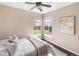 Bright bedroom with two windows, ceiling fan, and white and beige decor at 10606 Cottoneaster Way, Parker, CO 80134