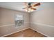 Bedroom featuring a wood-look floor, a ceiling fan, and a large window at 10606 Cottoneaster Way, Parker, CO 80134