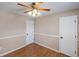 Bedroom with a ceiling fan, wood-look floor, and two doors at 10606 Cottoneaster Way, Parker, CO 80134