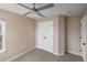 Bedroom with a ceiling fan, neutral walls, carpet, and a double door closet at 10606 Cottoneaster Way, Parker, CO 80134