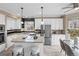 Bright kitchen featuring white cabinets, stainless steel appliances, and a central island with bar seating at 10606 Cottoneaster Way, Parker, CO 80134