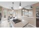 Bright kitchen featuring a stove top island, an eat-in area, and adjoins to the living room through an arched opening at 10606 Cottoneaster Way, Parker, CO 80134