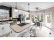 Bright kitchen featuring white cabinets, stainless steel appliances, a central island, and a dining table at 10606 Cottoneaster Way, Parker, CO 80134