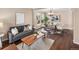 Cozy living room with hardwood floors, neutral walls, and stylish modern furniture at 10606 Cottoneaster Way, Parker, CO 80134