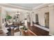 Spacious living room with hardwood floors, dining area, and an open staircase at 10606 Cottoneaster Way, Parker, CO 80134