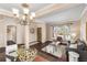 Open-concept living room with hardwood floors, large windows, and elegant decor at 10606 Cottoneaster Way, Parker, CO 80134