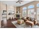 Comfortable living room with a stone fireplace, large windows, and an open layout at 10606 Cottoneaster Way, Parker, CO 80134