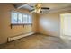 Bright bedroom with carpet, ceiling fan, and window at 800 W Belleview Ave # 407, Englewood, CO 80110