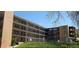 Apartment building with balconies, a grassy area, and a fence at 800 W Belleview Ave # 407, Englewood, CO 80110