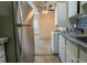 Kitchen with stainless steel refrigerator and in-unit laundry at 800 W Belleview Ave # 407, Englewood, CO 80110