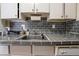 Close-up of kitchen sink and gray tile countertop at 800 W Belleview Ave # 407, Englewood, CO 80110