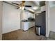 Small kitchen with appliances, gray tile, and in-unit laundry at 800 W Belleview Ave # 407, Englewood, CO 80110