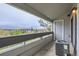 Cozy balcony overlooking green trees and distant buildings, perfect for outdoor relaxation at 14437 E 1St Dr # C09, Aurora, CO 80011