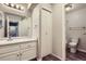 Bathroom featuring a single sink vanity, wood floor, and a closet for storage at 14437 E 1St Dr # C09, Aurora, CO 80011