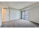 A bright bedroom featuring carpet, a slider to a patio, and a closet with white doors at 14437 E 1St Dr # C09, Aurora, CO 80011