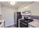 The kitchen features white cabinets, an electric range, and a stainless steel refrigerator at 14437 E 1St Dr # C09, Aurora, CO 80011