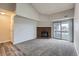 Spacious living room with a fireplace, high ceiling and a sliding glass door leading to a balcony at 14437 E 1St Dr # C09, Aurora, CO 80011