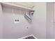 Small utility room with white shelves and hook ups for a washer and dryer at 14437 E 1St Dr # C09, Aurora, CO 80011