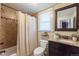 Updated bathroom with granite vanity, tiled shower, and a neutral color palette at 3560 N Columbine St, Denver, CO 80205