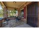 Inviting front porch with brick flooring and seating area at 3560 N Columbine St, Denver, CO 80205