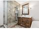Bathroom features a standalone glass shower and wood vanity with a framed mirror at 94 Spring Ln, Boulder, CO 80302