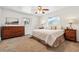 Bright bedroom with large windows, ceiling fan, and wood furniture at 94 Spring Ln, Boulder, CO 80302