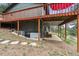 View of the deck with a red umbrella and the generator under the deck at 94 Spring Ln, Boulder, CO 80302