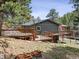 Multi-level wooden deck provides ample space for outdoor dining and entertainment with picturesque views at 94 Spring Ln, Boulder, CO 80302
