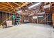 Spacious garage with exposed beams, concrete floor, and fluorescent lighting at 94 Spring Ln, Boulder, CO 80302