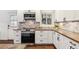 Well-lit kitchen with white cabinets and updated appliances providing a clean and functional space at 94 Spring Ln, Boulder, CO 80302