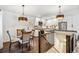 Open-concept kitchen with stainless appliances, white cabinets, and a cozy breakfast nook at 94 Spring Ln, Boulder, CO 80302