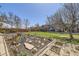 Landscaped backyard features a mulched garden bed and mature trees for privacy at 11123 Clermont Dr, Thornton, CO 80233
