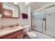 Full bathroom with tile shower, tub and oak cabinets at 11123 Clermont Dr, Thornton, CO 80233