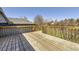 Wooden deck overlooking backyard features a railing and built-in lighting at 11123 Clermont Dr, Thornton, CO 80233