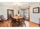 Inviting dining room featuring hardwood floors, sliding glass door, and elegant chandelier at 11123 Clermont Dr, Thornton, CO 80233