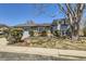 Charming home featuring stone accents, mature trees, and manicured landscaping at 11123 Clermont Dr, Thornton, CO 80233